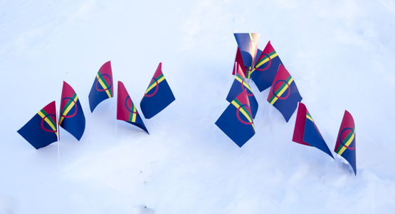 Samiska papperflaggor som satts ner i snö